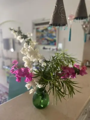 a vase filled with flowers sitting on a counter at Beit Matta in Hurghada