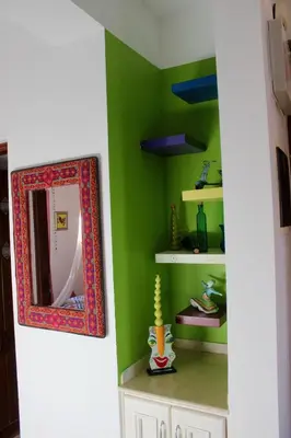 a room with a mirror and green walls at Beit Matta in Hurghada