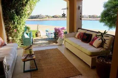 a living room with a couch and a view of the beach at Beit Matta in Hurghada