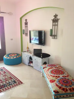 a living room with a flat screen tv on the wall at Beit Matta in Hurghada