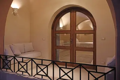 a living room with a window and a couch at Malkata House - Boutique hotel and restaurant in Luxor