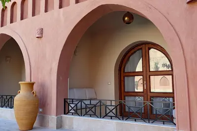 a large vase sitting in front of a door at Malkata House - Boutique hotel and restaurant in Luxor