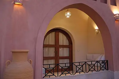 a room with a door and a vase on a balcony at Malkata House - Boutique hotel and restaurant in Luxor