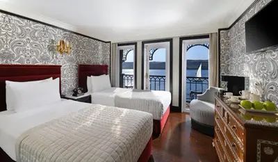 a hotel room with two beds and a balcony at Movenpick SS Misr Steamer Nile Cruise - 04 & 07 Nights Each Monday From Luxor and 03 Nights Each Friday from Aswan in Luxor