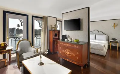 a room with a bedroom with a bed and a mirror at Movenpick SS Misr Steamer Nile Cruise - 04 & 07 Nights Each Monday From Luxor and 03 Nights Each Friday from Aswan in Luxor