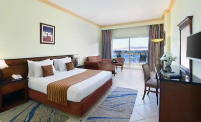 a hotel room with a bed and a living room at Tolip Aswan Hotel in Aswan