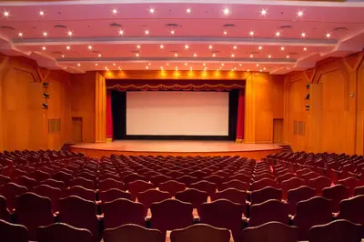 an auditorium with a large screen in front of a stage at Tolip Aswan Hotel in Aswan