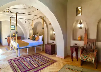 a bedroom with a canopy bed in an archway at Djorff Palace in Luxor