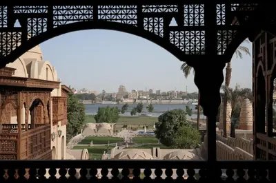 a view of a park from a window of a building at Djorff Palace in Luxor
