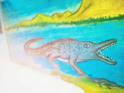 a painting of a dinosaur in the water at Elephantina sobek guest house in Aswan