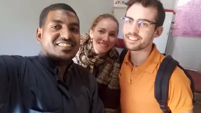 two men and a woman posing for a picture at Elephantina sobek guest house in Aswan