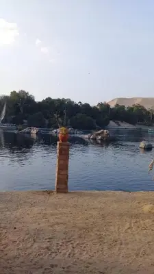 a brick pillar with a plant in the middle of a body of water at Elephantina sobek guest house in Aswan