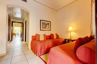 a hotel room with two beds and a couch at TUI MAGIC LIFE Kalawy in Hurghada
