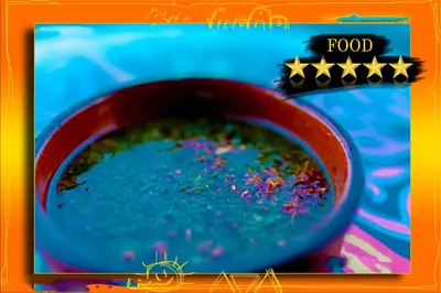 a red bowl of food with confetti in it at Opal privat nubian hotel in Aswan