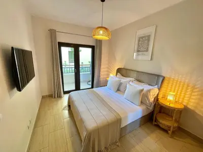 a bedroom with a bed with a large window at Luxury Hurghada Self-Catering Apartments & Studios, Al Dau Heights in Hurghada