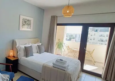 a bedroom with a bed and a balcony at Luxury Hurghada Self-Catering Apartments & Studios, Al Dau Heights in Hurghada