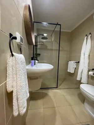 a bathroom with a sink and a glass shower at Luxury Hurghada Self-Catering Apartments & Studios, Al Dau Heights in Hurghada