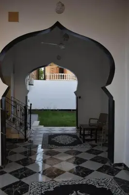 an archway in a building with a view of a yard at Alaa Aldin Flats in Luxor