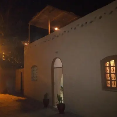 a white building at night with lights on it at Desert Rose Guesthouse in Luxor