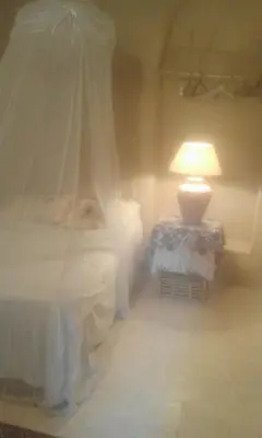 a bedroom with two beds and a lamp on a table at Desert Rose Guesthouse in Luxor