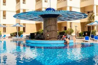 a woman in the swimming pool at a hotel at AMC Royal Hotel & Spa in Hurghada
