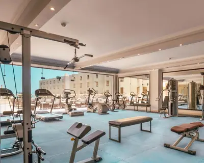 a gym with a lot of treadmills and machines at AMC Royal Hotel & Spa in Hurghada