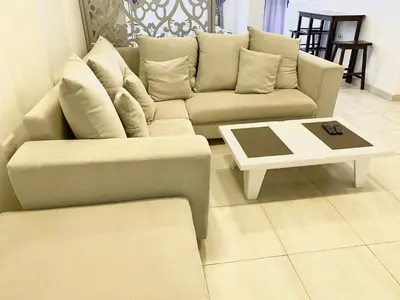 a living room with a couch and a coffee table at Marilyn Studio with Sea View Wi Fi in Hurghada