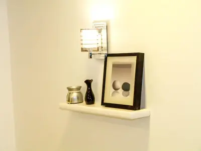 a shelf with a mirror and a vase on it at Marilyn Studio with Sea View Wi Fi in Hurghada