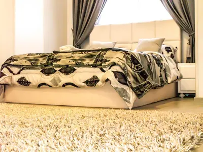 a bedroom with a bed with a blanket on it at Marilyn Studio with Sea View Wi Fi in Hurghada