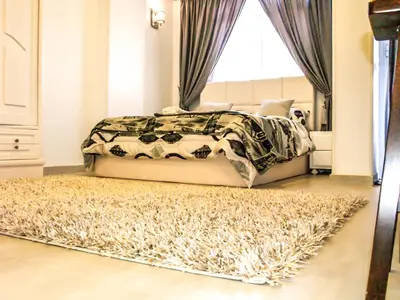 a bedroom with a bed and a rug at Marilyn Studio with Sea View Wi Fi in Hurghada