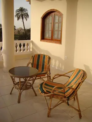 two chairs and a coffee table in a room at Hermina Guest House in Luxor