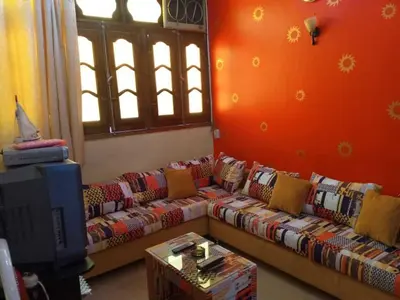 a living room with a couch and a tv at Roma House in Aswan