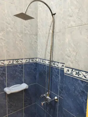a bathroom with a shower with a toilet in it at Roma Guest house in Aswan