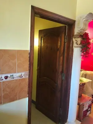 an open wooden door in a room at Roma Guest house in Aswan