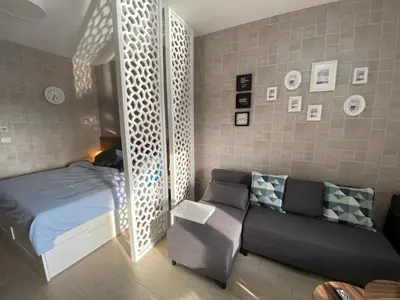 a bedroom with a bed and a couch and a mirror at Awesome Pool View Studio in Al Dau Heights in Hurghada