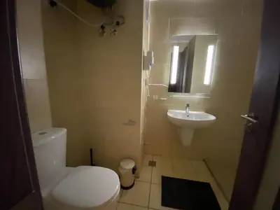 a bathroom with a white toilet and a sink at Awesome Pool View Studio in Al Dau Heights in Hurghada