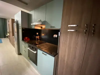 a kitchen with white cabinets and a counter top at Awesome Pool View Studio in Al Dau Heights in Hurghada