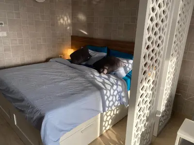 a bedroom with a large bed with blue sheets at Awesome Pool View Studio in Al Dau Heights in Hurghada