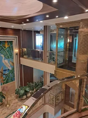 a living room with a spiral staircase in a building at MS Chateau Lafayette Nile Cruise - 4 nights from Luxor each Monday and 3 nights from Aswan each Friday in Luxor
