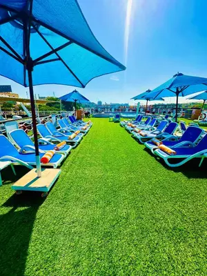 a row of lounge chairs and umbrellas on a beach at MS Chateau Lafayette Nile Cruise - 4 nights from Luxor each Monday and 3 nights from Aswan each Friday in Luxor