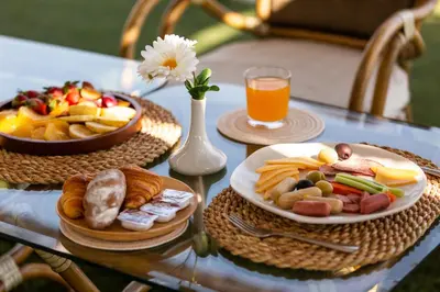 a table with a plate of food and a bowl of fruit at MS Chateau Lafayette Nile Cruise - 4 nights from Luxor each Monday and 3 nights from Aswan each Friday in Luxor