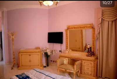 a bedroom with a mirror and a chair and a tv at Villa with Private Pool in Hurghada