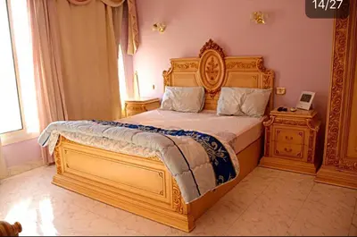 a bedroom with a large bed with a wooden frame at Villa with Private Pool in Hurghada