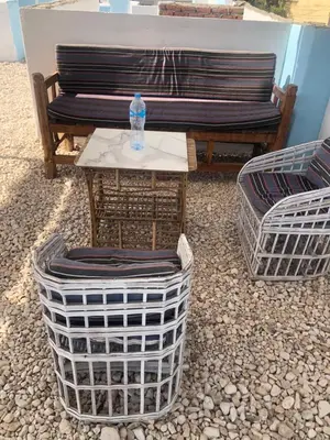 a table with a bottle of water on it next to a bench at Luxor Best Way in Luxor
