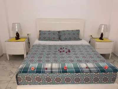 a bedroom with a bed with two night stands at Luxor Best Way in Luxor