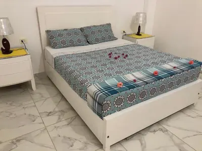 a bedroom with a bed with two night stands at Luxor Best Way in Luxor