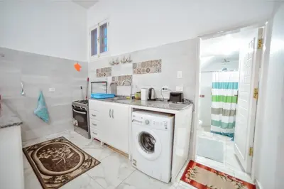 a white laundry room with a washer and dryer at Luxor Best Way in Luxor