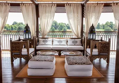 a living room with a couch and chairs on a balcony at Dahabeya Yakouta Nile Cruise-Every Monday from Luxor- Aswan for 05 nights in Luxor