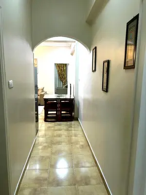a hallway with an archway and a desk in a room at Karnak Flats in Luxor
