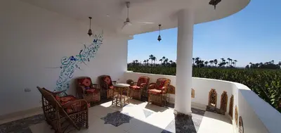 a group of chairs and a table in a room at Dar Lina Guesthouse Luxor in Luxor